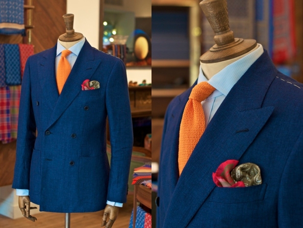 In this ensemble, the orange knit tie is matched with a complimentary red/green pocket square.