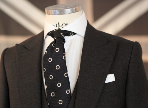 The iconic classic look white pocket square with dark suit. Simple 
