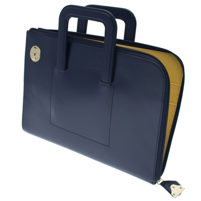 This navy leather zipped portfolio case which opens top and side is from Ettinger's Metropolitan Collection. The spacious internal compartment contains two pockets that hold A4 papers and four additional pockets perfect for smaller documents, smartphones, wallets and credit cards. The zip closes with a brass lock to guarantee complete security of contents. Two retractable handles means the Bakerloo portfolio may be carried as a case or under the arm.