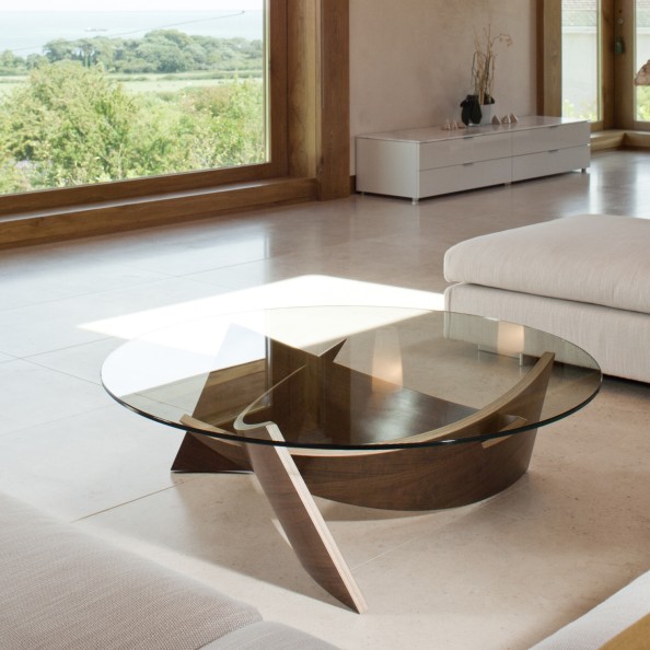 The Expose Coffee Table consists of complex laminations of birch ply and wood veneer which interlock at angles. Together, they form a three-point leg structure that supports a toughened glass top. The birch ply is left exposed on the edges, forming a pleasing contrast with the surface veneer and ensuring that the design remains true to its materials.