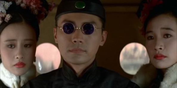 John Lone portrays Pu Yi in Bertolucci's The Last Emperor. He's wearing round sunglasses.