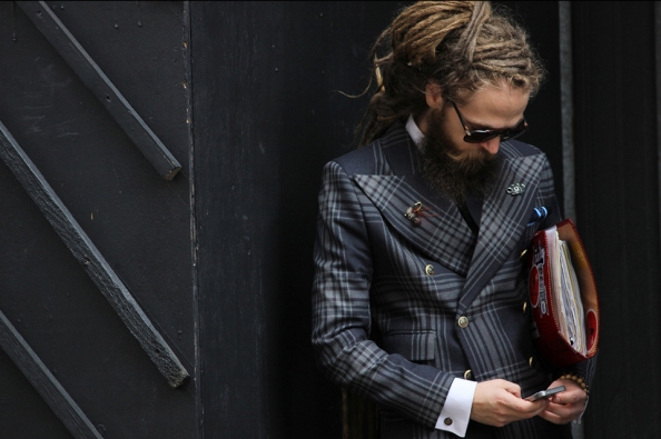 This man captured at London Men's Collection last June looks fantastic because even rocking a Double Breasted (with its extra material), he looks fitted. It helps that he has accessorised to the nines, from surprising dreadlocks to his buttonhole accessories, right down to the pattern and gold buttons he picked for his suit.