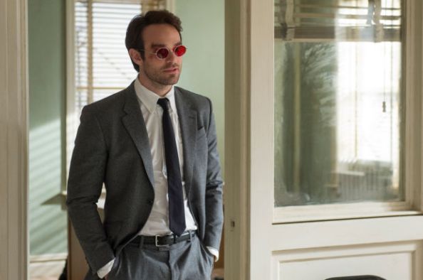 Structured well fitted flannel suit and black tie are key anchors of his style. His red tinted glasses are an accent, serving as able point of focus in lieu of missing pocket square, which would also be a bitch to fold when one lacks visual senses.