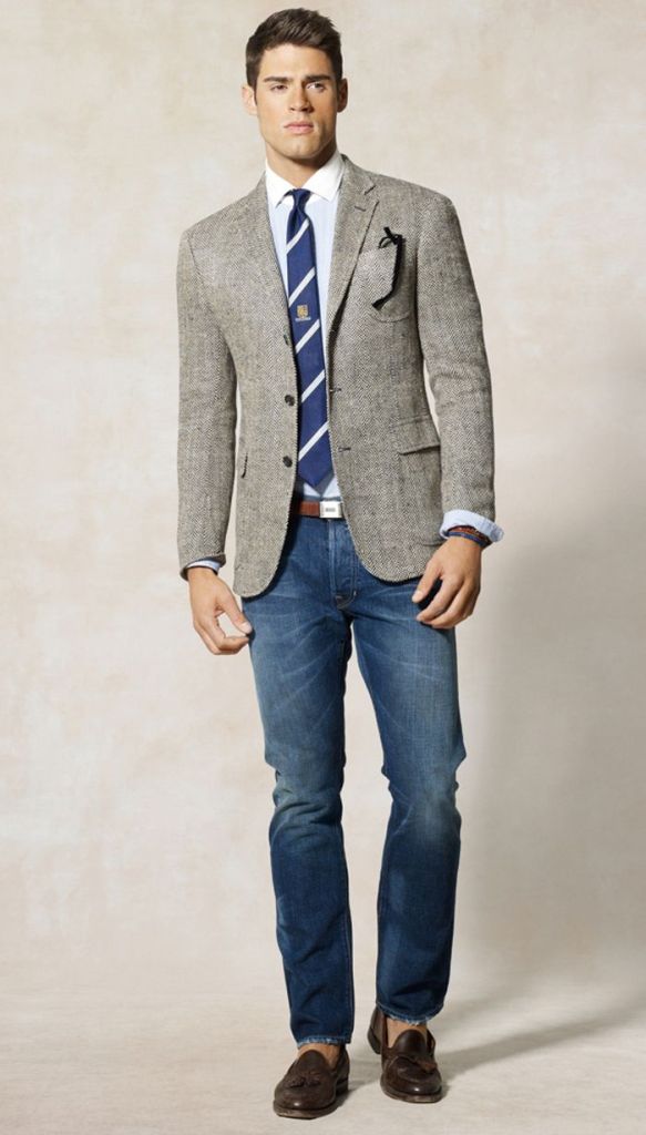 Your blazer and tie ensemble is dressed down with the strategic use of denim jeans and loafers worn sockless.